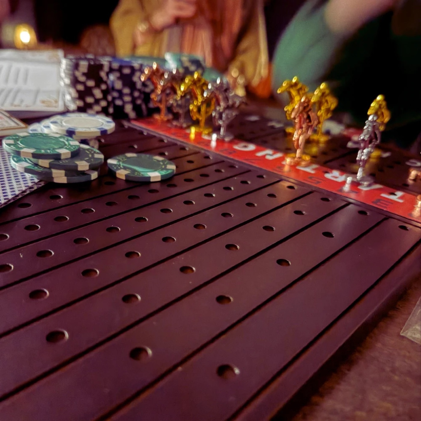 A horse racing board game with poker chips on a table